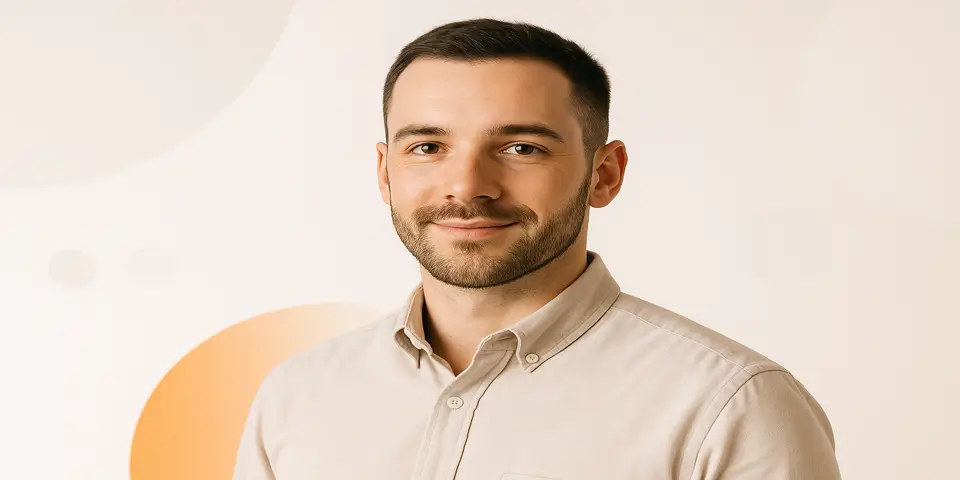 Portrait of a young South Asian digital marketer smiling confidently.